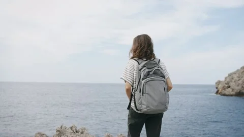 A young tourist with a backpack enjoys the view Stock Footage 258560527