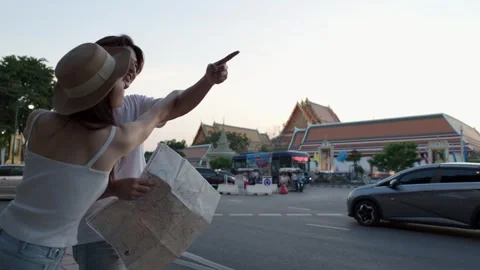 Young Tourist Couple Reading Map on Busy Bangkok Street Stock Footage 323352270
