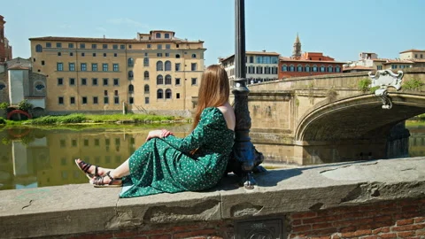 A young tourist looking at Ponte Vecchio bridge in Florence, Italy. Stock Footage 237082206