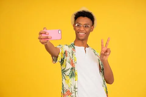 Young tourist man taking selfies with a mobile phone. Stock Photos