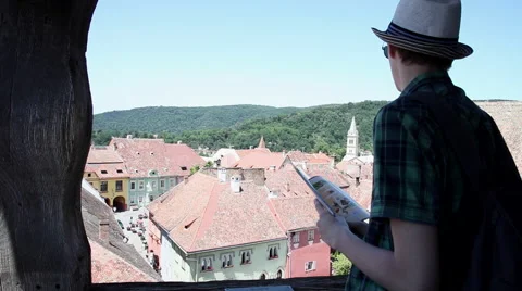 Young tourist using map, high angle view, Transylvania, old town, UNESCO Stock Footage 44893006