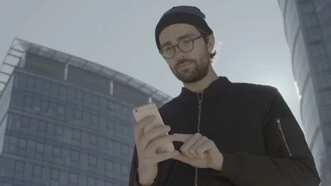 Young Tourist Using a Mobile Phone in the City. Skyscrapers Stock Footage 81206110