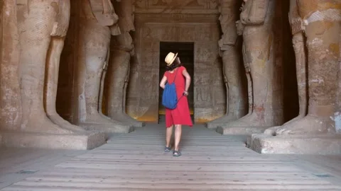 A young tourist visiting the sculptures inside the temple of Abu Simbel Stock Footage 142157189