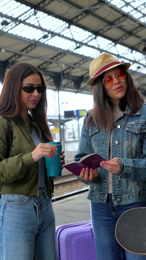 Young tourists checking passports and train schedule at station Stock Footage 311809502