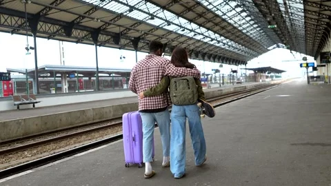 Young tourists couple walking in train station Stock Footage 311809511