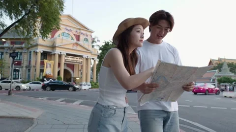 Young Tourists Reading City Map on Bangkok Street Stock Footage 323352520