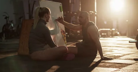 Young trainee and coach discussing on weightlifting topics Stock Footage 272374589