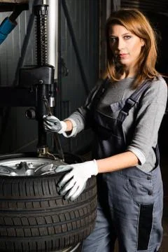 Young trainee changing  car tyre Stock Photos