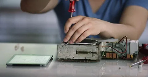Young trainee opening old radio speaker; close up Stock Footage 78577641
