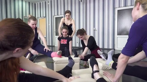 Young trainer helping her trainees to stretch Stock Footage 75533062