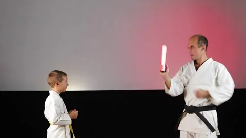 A young trainer teaches a young athlete to do hand blocks Stock Footage 341557520