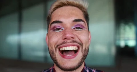 Young transgender man with makeup laughing on camera outdoor Stock Footage 175793553