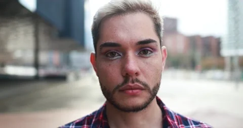 Young transgender man with makeup looking on camera outdoor Stock Footage 175792406