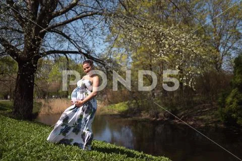 Young traveler pregnant woman walking, running, turning around and enjoys her Stock Photos
