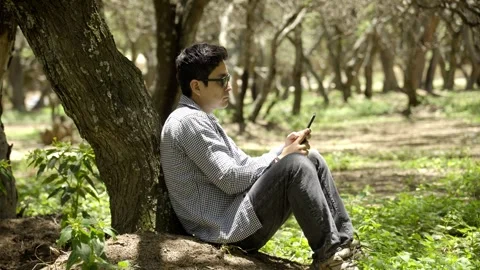 Young traveler resting from using a cell phone to enjoy nature Stock Footage 272282527