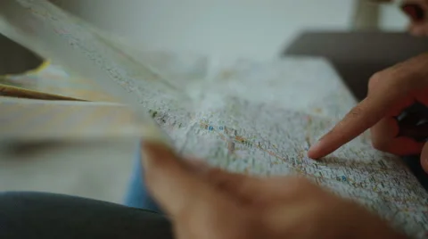 Young travelers taking a look on a map close up Stock Footage 68722897