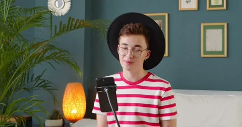 Young trendy vlogger look at camera talk make recording live video stream Stock Footage 135530557