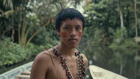 Young tribe man in a canoe looking at the camera Stock Footage 270462144