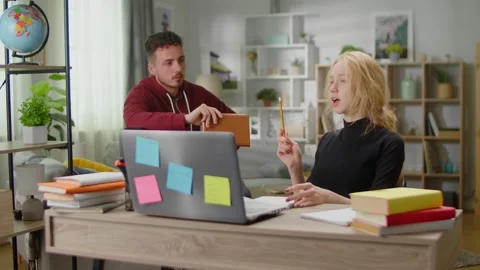 Young tutor man is studying with a young... | Stock Video | Pond5