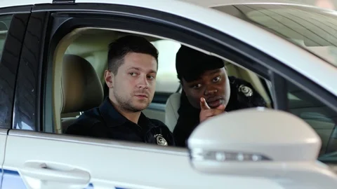 Young two men cops sitting in patrol car accepting emergence call enforcement Stock Footage 112958391