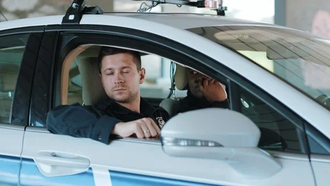 Young two men cops sitting in patrol car accepting emergence call enforcement Stock Footage 113000223