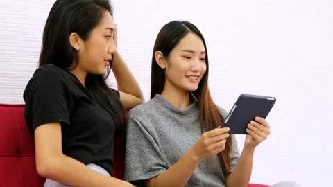 Young two woman using tablet and credit card for shopping online. Stock Footage 133097652