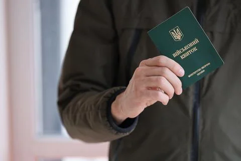 Young ukrainian conscript soldier shows his military token or army ID ticket Stock Photos