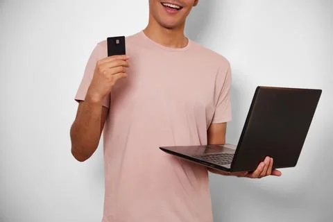 Young unrecognizable man making use of his card in online shopping Stock Photos