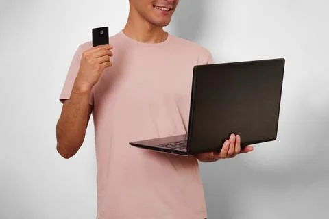 Young unrecognizable man making use of his card in online shopping Stock Photos