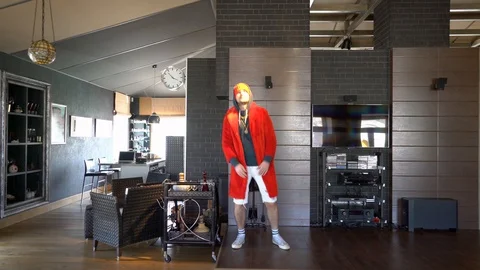 Young unusual guy funny dressed in a red coat Stock Footage 128868614