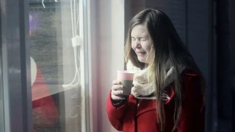 Young upset girl remembering ex-boyfriend and drinking tea 库存影片 71584891