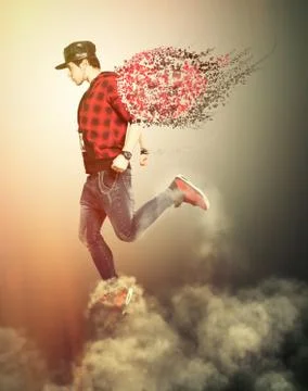Young urban guy walking on the clouds in the sky. The man is pushed up by the Stock Photos