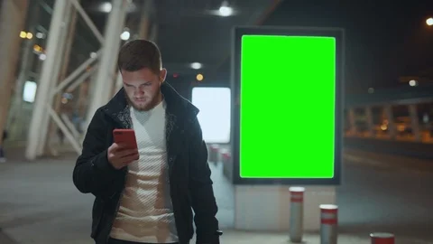 Young urban man using smartphone embarassed with news showing anger and Stock Footage 117430651