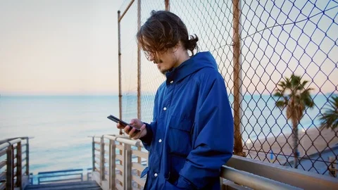 Young using mobile social network app to be up to date and connected to internet Stock Footage 100862611