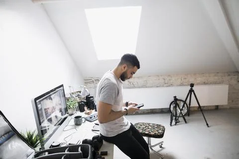 Young using phone in creative studio Stock Photos