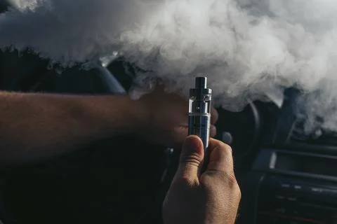Young vaper man with beard vaping mechanical mod Stock Photos