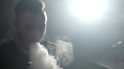 Premium Photo  Vape man exhales a cloud of steam neon light