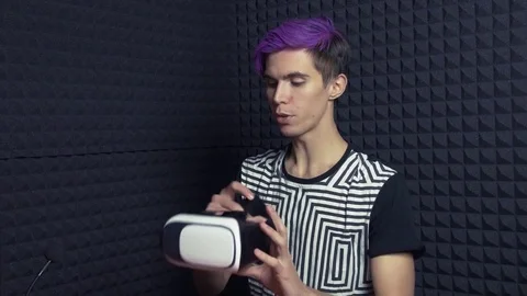 Young videoblogger with purple bang in web studio making review of vr glasses Video stock 70804533