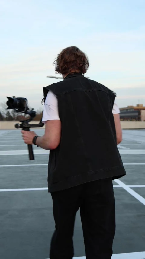 Young videographer filming on roller skates in motion Stock Footage 332116777