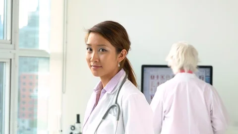 Young Vietnamese doctor looking into camera. 库存影片 94152489