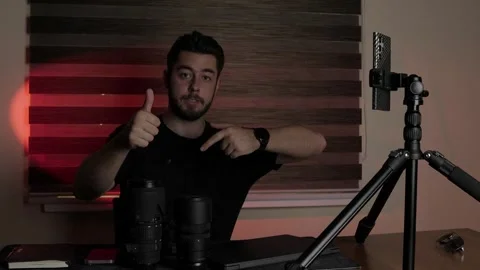 Young vlogger-content creator recording a video lesson in a professional studio Stock Footage 323168080