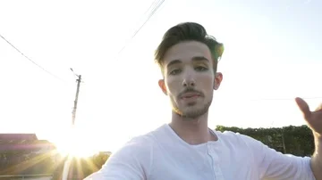 Young vlogger taking camera from the ground walking and talking while recordi Video stock 86138302