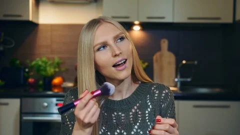 Young vlogger talking about makeup brush. Attractive young woman talking about Video stock 95776671
