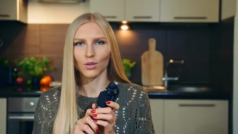 Young vlogger talking about selfie stick. Attractive young woman talking about Stock Footage 95807424