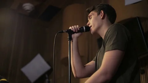 Young Vocalist Singing to the Microphone Stock Footage 72220877