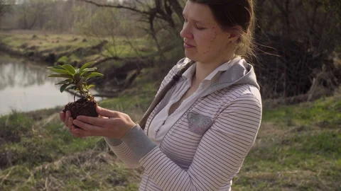 Young volunteer with the small tree in her hands Video stock 107469243