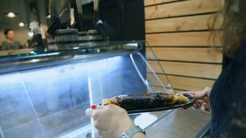 A young waiter in the restaurant serving fried-backed cheese in dough Stock-Footage 104161493