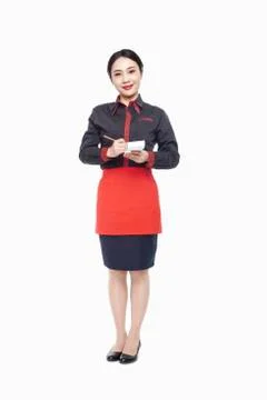 Young Waitress writing order on note pad, smiling, studio shot Photos