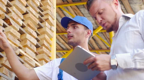 Young warehouse worker timber to communicate with customers Stock Footage 57096124