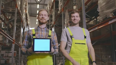 Young warehouse workers with tablet computer for online trading in warehouse Stock Footage 123280335